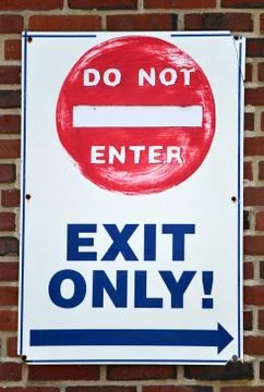 A white sign reading Do Not Enter, Exit Only 스톡 사진