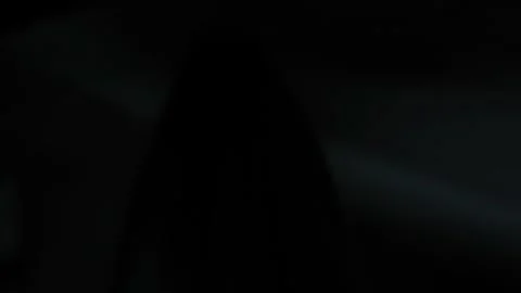 White silhouette of a ghost in a dark room with a flashing light. Stock Footage 308574974