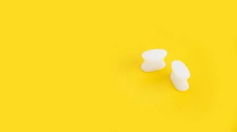 White silicone finger divider on a yellow background Stock Photos