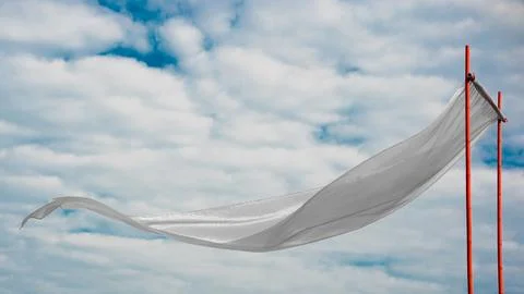 White silk fabric develops against the background of white clouds Stock Photos