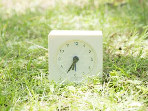 White simple clock on lawn yard, 6:35 six thirty five Foto stock
