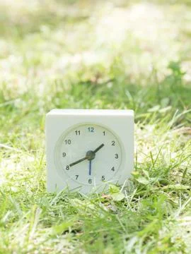 White simple clock on lawn yard, 1:40 one forty Stock Photos