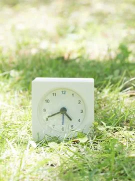 White simple clock on lawn yard, 4:40 four forty Stock Photos
