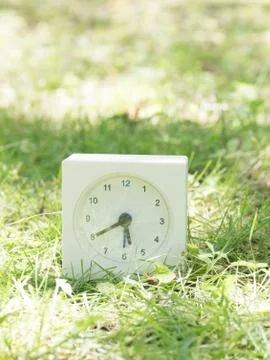 White simple clock on lawn yard, 5:40 five forty Stock Photos
