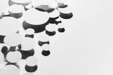 White simple geometric background with flying ovals in hard light with contra Stock Photos