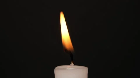 White single Candle flickering in the dark. Side view. White candle burning on Stock Footage 205740134