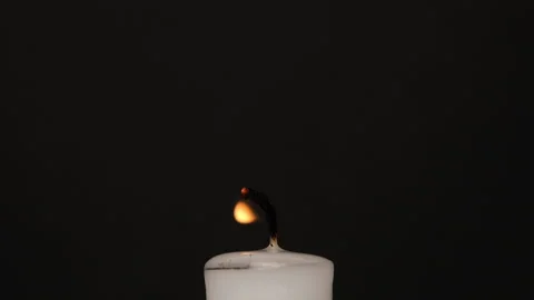 White single Candle flickering in the dark. Side view. White candle burning on Stock Footage 209351973
