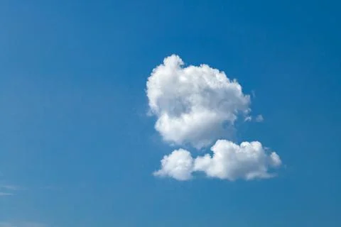 White single fluffy cloud on a blue sky background Stock Photos