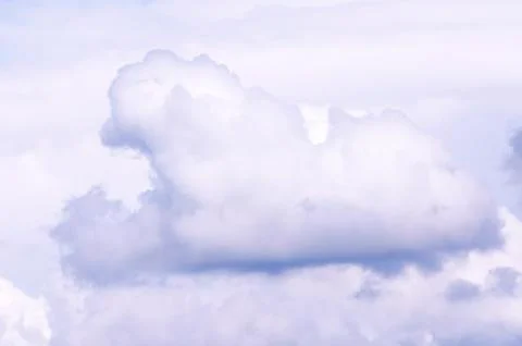White sky and puffy clouds Stock Photos