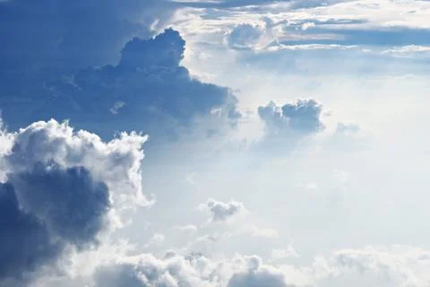 White sky and puffy clouds Stock Photos