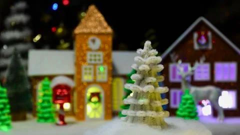White small Christmas tree moves against the background of a Christmas town Stock Footage 294682885
