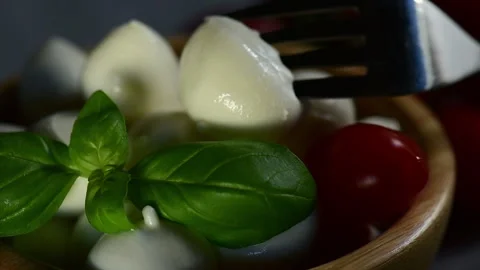White small mozzarella cheese balls with basil leaf put on Stock Footage 153272299