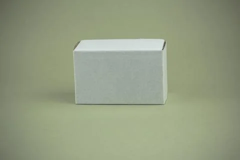 White small paper box on gray olive background Stock Photos