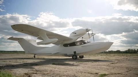 White small plane on the runway. There is a small sports plane on the runway. Stock Photos