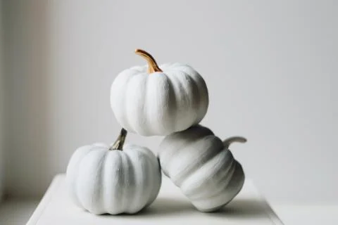 White small pumpkins on a white background Fotos de archivo