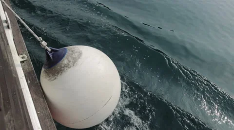 White small rubber buoy for protecting moored yachts in marina Stock Footage 49928516