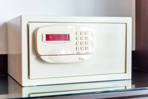 White small safe with coded lock on the table in the hotel close-up Stock Photos