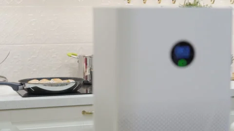 White smart air purifier with digital display showing humidity, temperature and Stock Footage 167420135