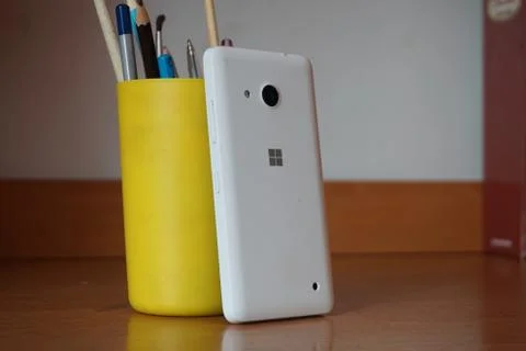 A white smartphone on the table Stock Photos