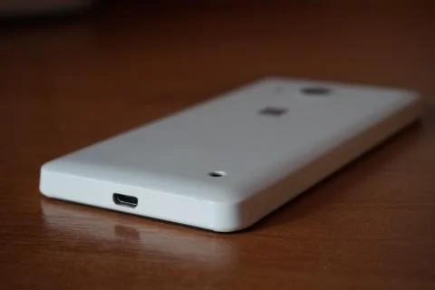 A white smartphone on the table Stock Photos
