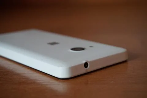 A white smartphone on the table Stock Photos