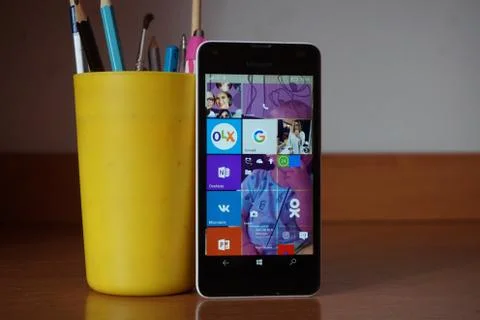 A white smartphone on the table Stock Photos