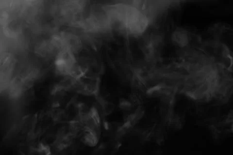 White smoke on a black background. Texture of smoke. Clubs of white smoke o.. Stock Photos