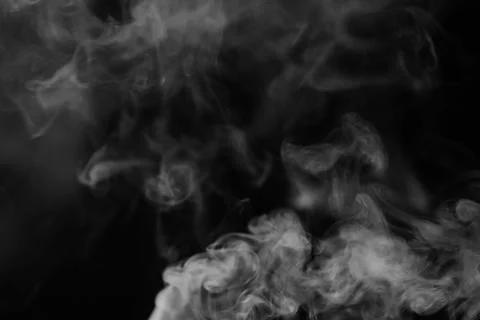 White smoke on a black background. Texture of smoke. Clubs of white smoke o.. Stock Photos