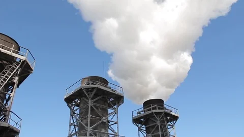 White smoke comes from the factory pipes against the blue sky Stock Footage 76108053