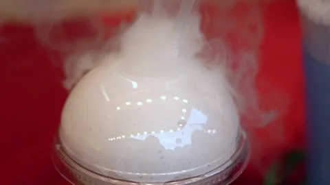 White smoke coming out from a plastic glass with straw Stock Footage 297478296