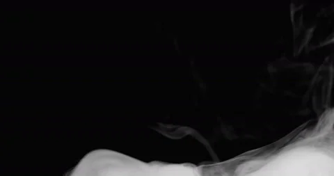 White smoke floating through space against black background Stock Footage 129961048