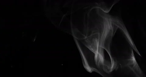 White smoke floating through space against black background Stock Footage 145179357