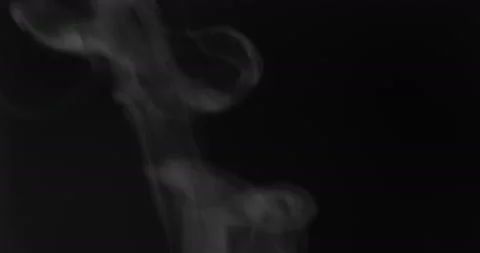 White smoke floating through space against black background Stock Footage 146645494