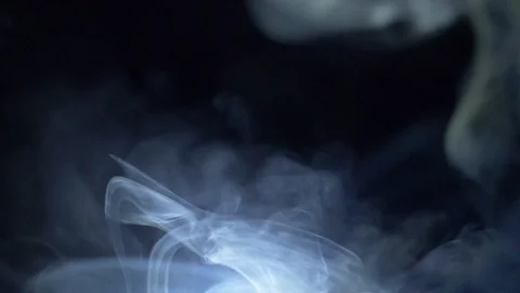 White smoke in the light on a black background Stock Footage 105238112