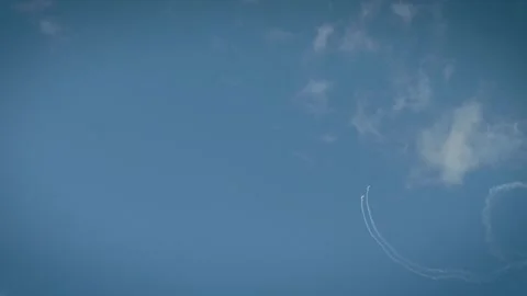 A white smoke loop pattern created by an aerobatic airplane in a clear blue sky Stock Footage 340206236