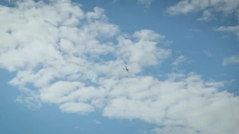 A white smoke loop pattern created by an aerobatic airplane in a clear blue sky Stock Footage 340394308