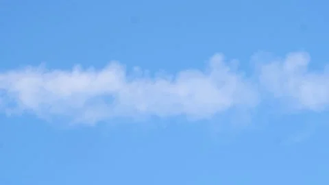 White smoke passes in slow motion in the blue sky Stock Footage 234550274