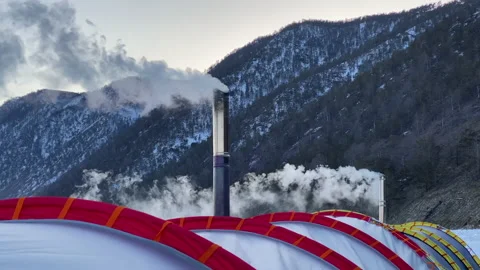 White smoke pours from the chimneys of two stoves of a large winter tent Stock-Footage 151064278