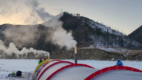 White smoke pours from the chimneys of two stoves of a large winter tent Stock-Footage 151136418