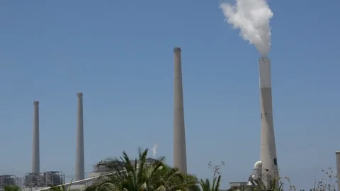 White smoke rises from the striped pipe into the blue cloudless sky on a bright, 動画素材 91440936