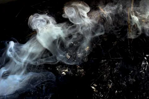White smoke spiraling from the fire Stock Photos