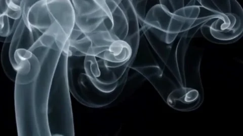 White smoke trails coiling and swirling against a deep black background. Stock Footage 340318410