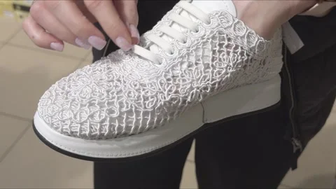White sneaker with voluminous textured upper in a shopper's hands Stock Footage 332768762