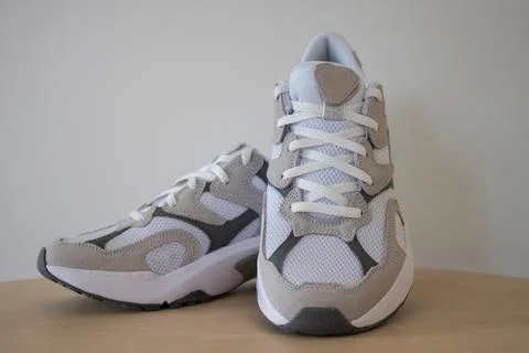 White sneakers with suede on the background Stock Photos