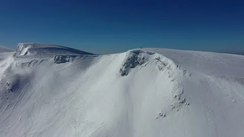 White snow-capped mountains against clear blue sky. ski tracks on wild slopes Stock Footage 155278155