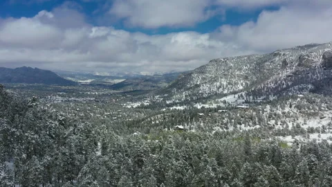 The white snow is in contrast to the evergreens and blue sky in Colorado Stock Footage 247364191