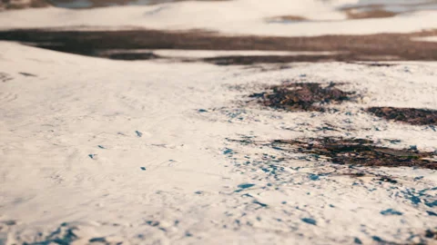 White snow covers the ground in a landscape with patches of earth visible Stock Footage 339504452