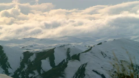 White snow in distant hills with low clouds Stock Footage 159702078