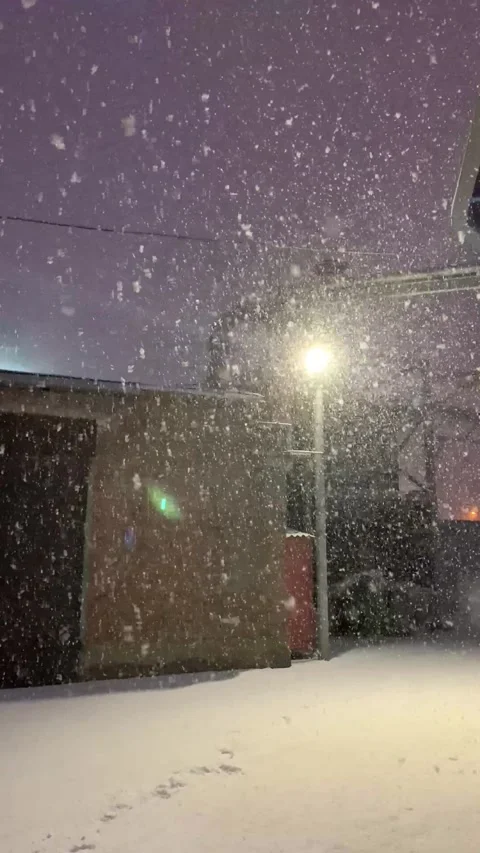 White snow falling in the night by the light of a lantern Stock Footage 152109097