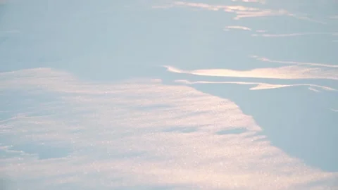 White snow illuminated by the rays of the bright sun. Close-up. Video stock 233314737